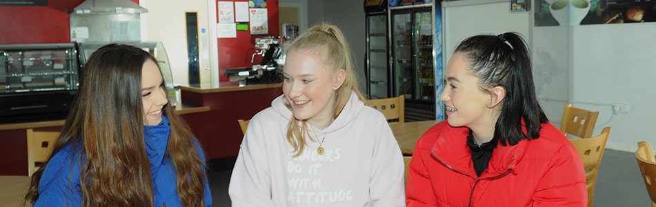 girls smiling at each other